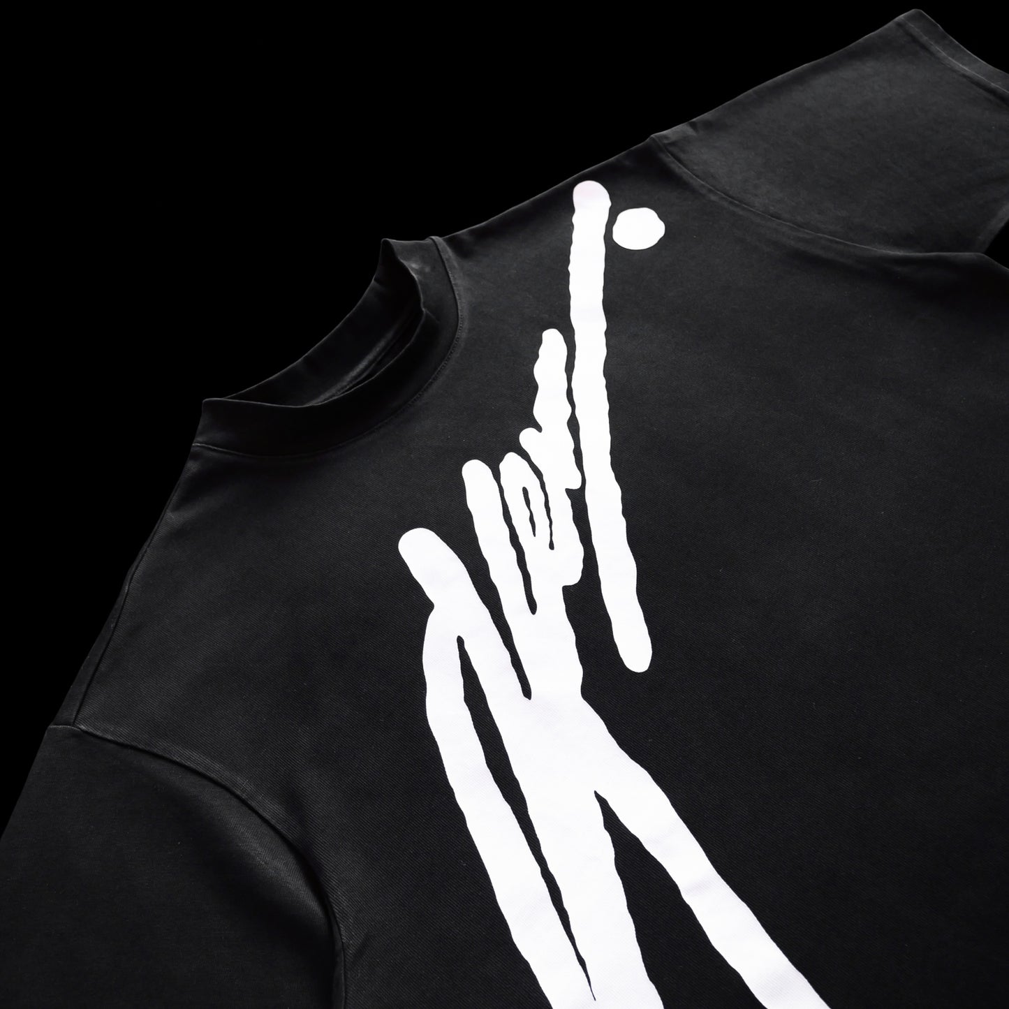 Black t-shirt with white graphic design on a black background