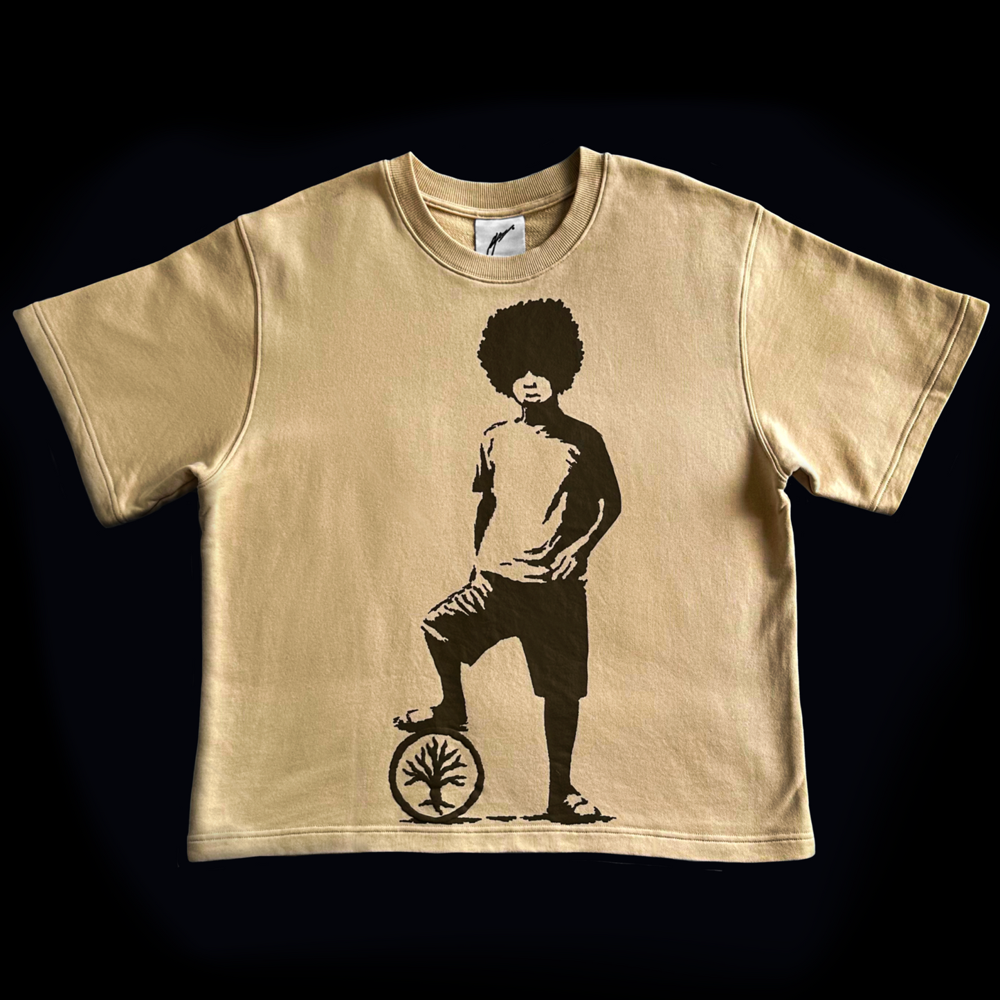 Beige t-shirt with a graphic of a person on a unicycle on a black background