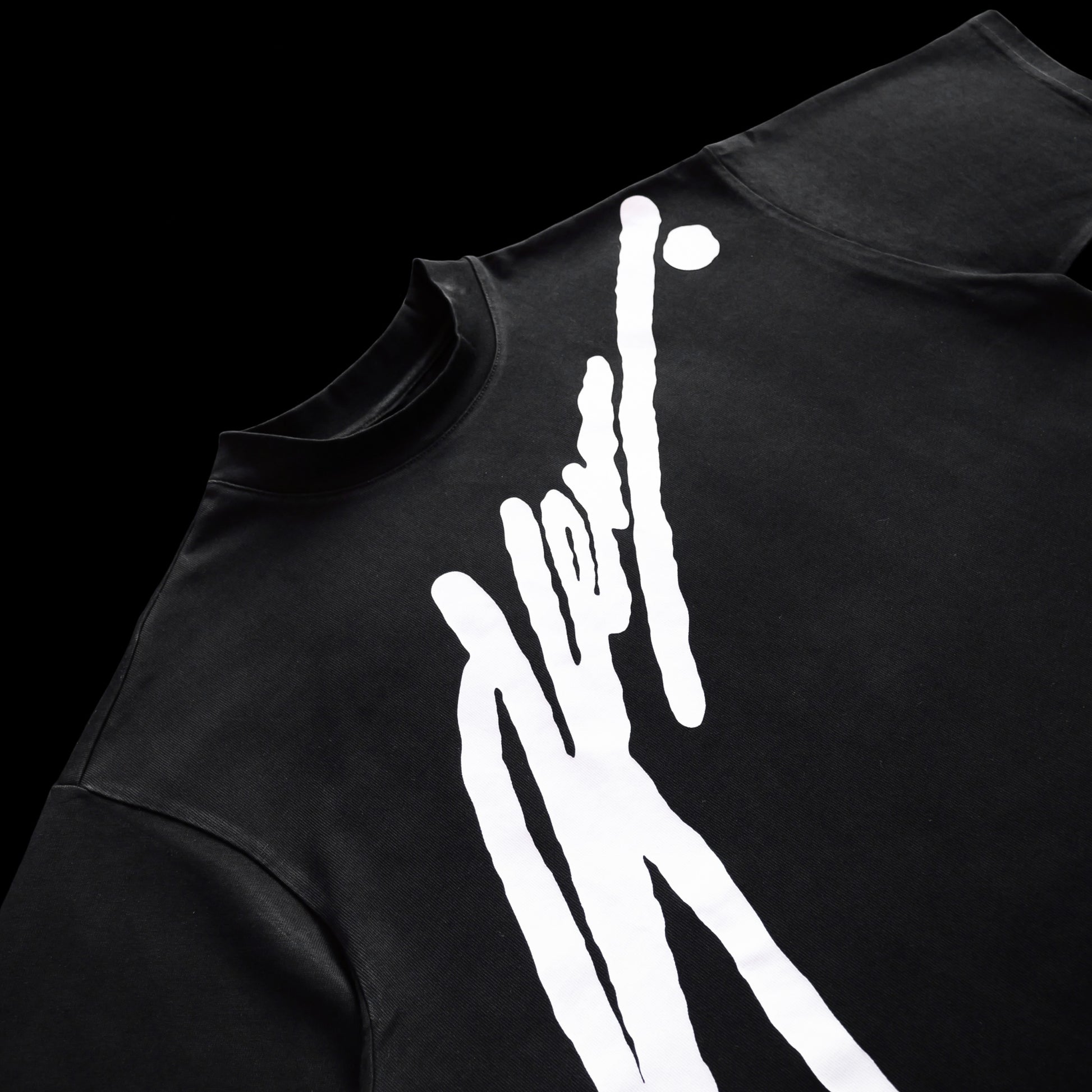 Black t-shirt with white graphic design on a black background