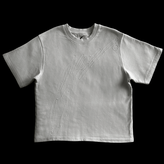 White t-shirt with black embroidered design on a black background