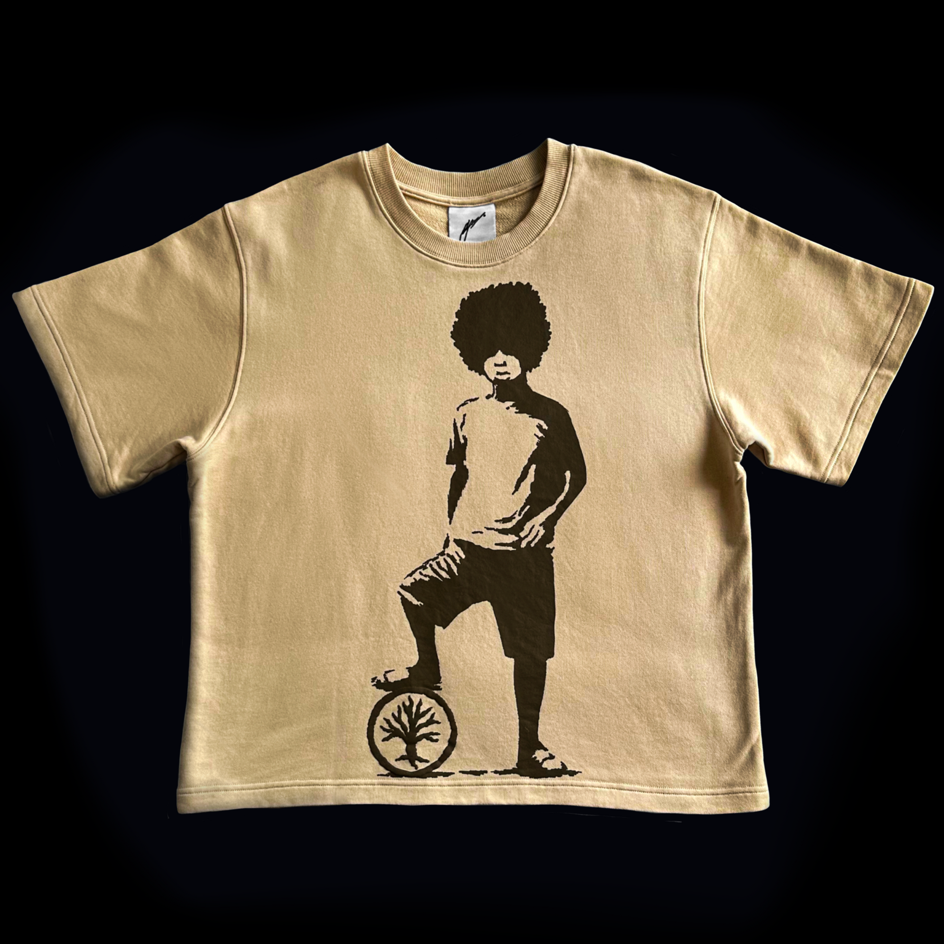Beige t-shirt with a graphic of a person on a unicycle on a black background