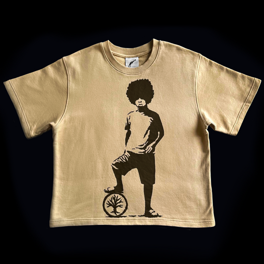 Beige t-shirt with a graphic of a person on a unicycle on a black background